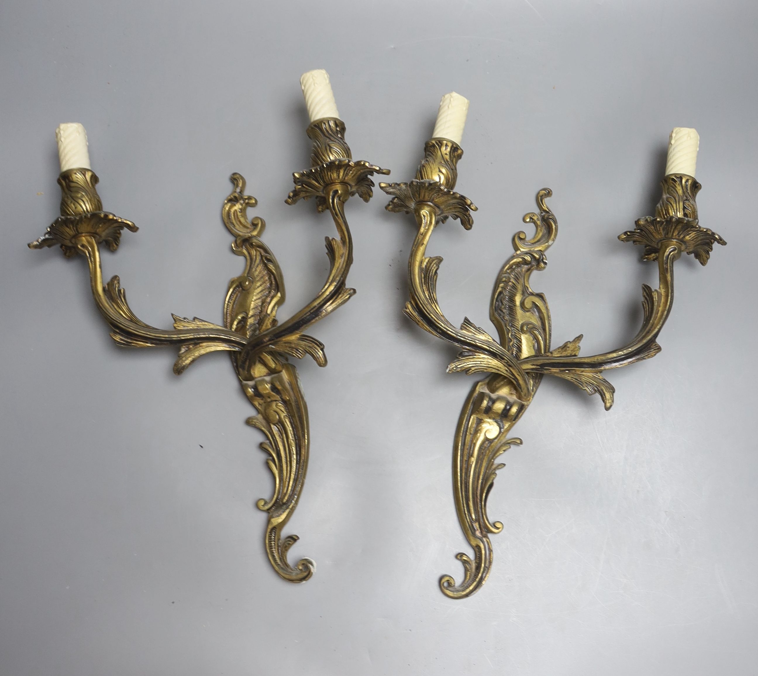 A pair of rococo style twin light wall sconces, and an Italian period style giltwood table lamp, height 56cm